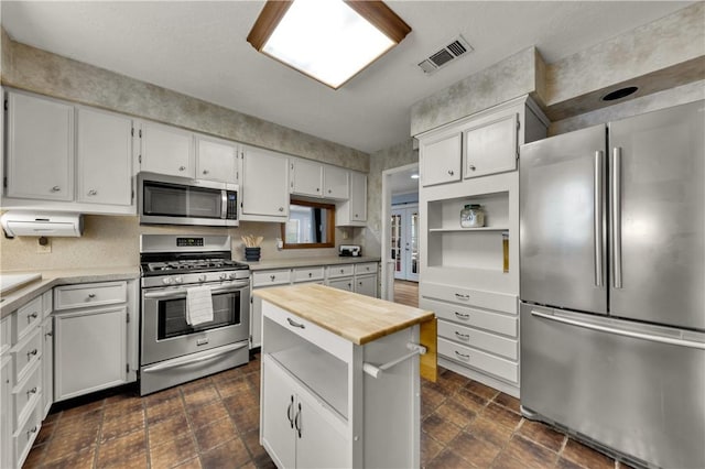 kitchen with white cabinetry and stainless steel appliances