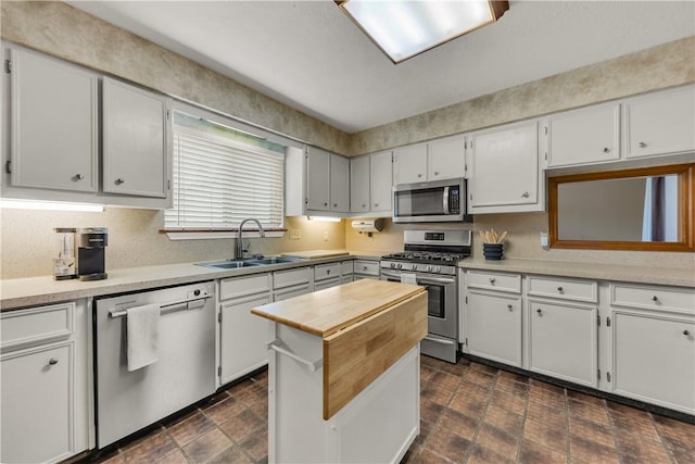 kitchen featuring white cabinetry, sink, and stainless steel appliances