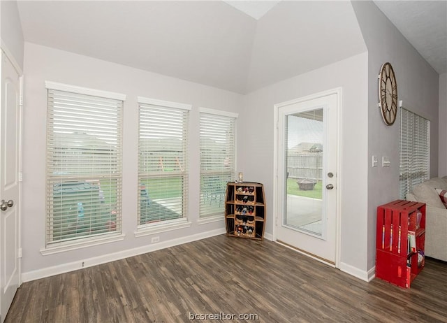 empty room with dark hardwood / wood-style floors and lofted ceiling