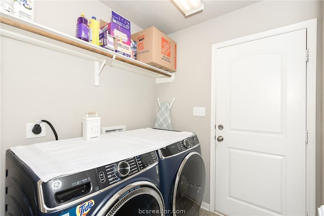 clothes washing area featuring washing machine and dryer