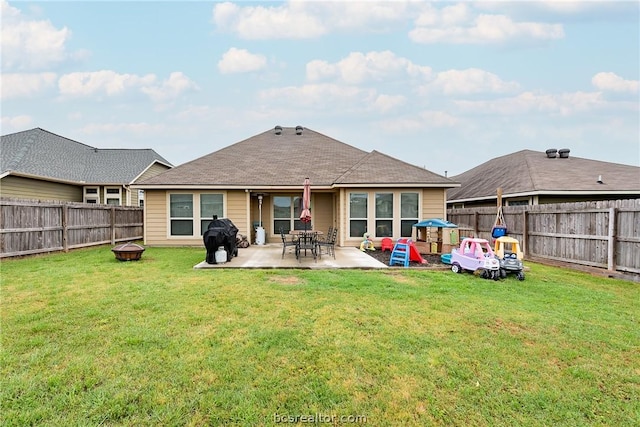 rear view of house with a patio, an outdoor fire pit, and a lawn