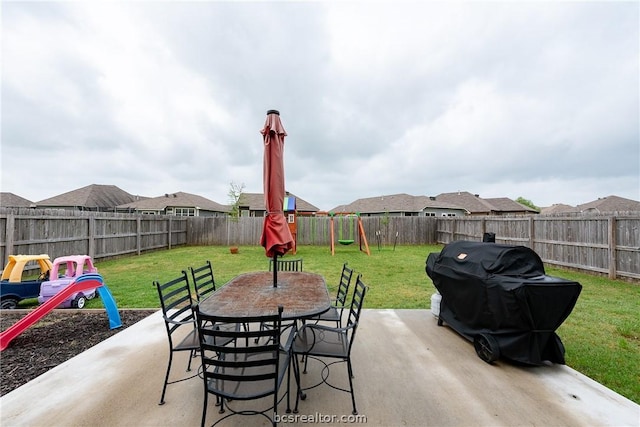 view of patio featuring a playground and area for grilling