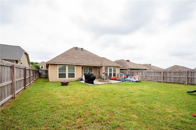 rear view of house with a patio area and a yard