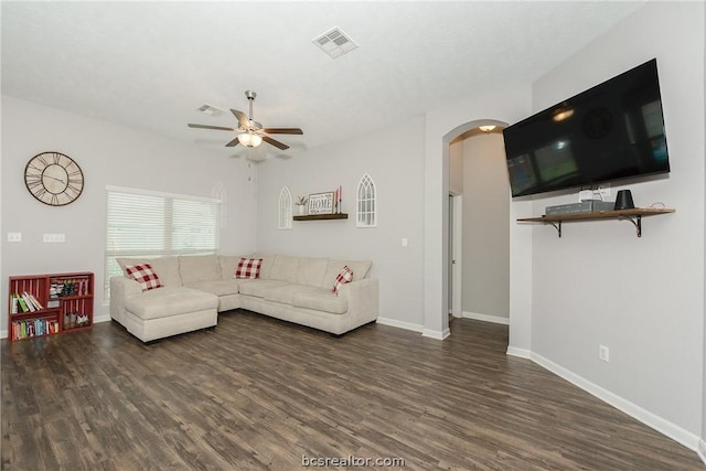 living room with ceiling fan and dark hardwood / wood-style flooring