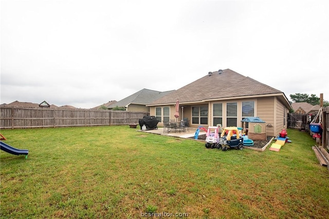 rear view of property with a patio area and a lawn