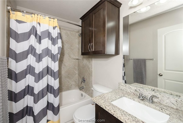 full bathroom featuring shower / bath combo with shower curtain, vanity, a textured ceiling, and toilet