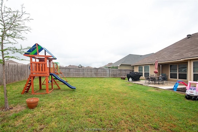 view of yard featuring a playground and a patio area