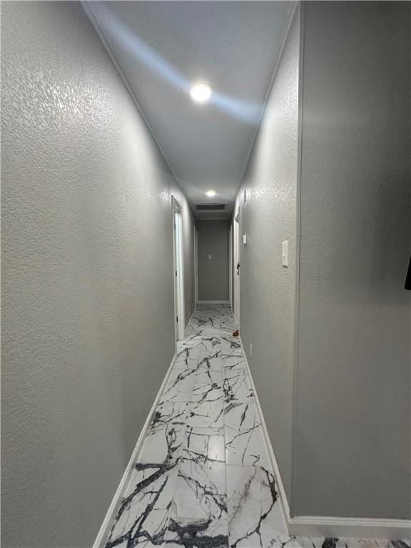 1906 Calvert Cir, Bryan, TX 77803 - hallway featuring light marble finish flooring, recessed lighting, and a textured wall