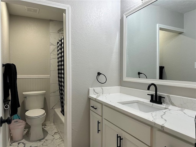 1906 Calvert Cir, Bryan, TX 77803 - bathroom featuring marble look tile flooring, vanity, and shower / bathtub combination with curtain
