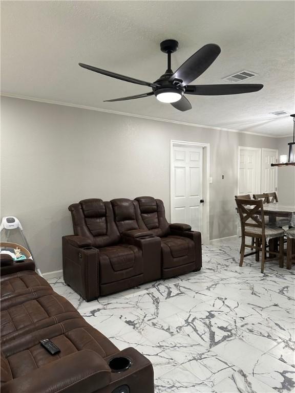 1906 Calvert Cir, Bryan, TX 77803 - living room featuring ceiling fan, light marble finish flooring, ornamental molding, and a textured ceiling