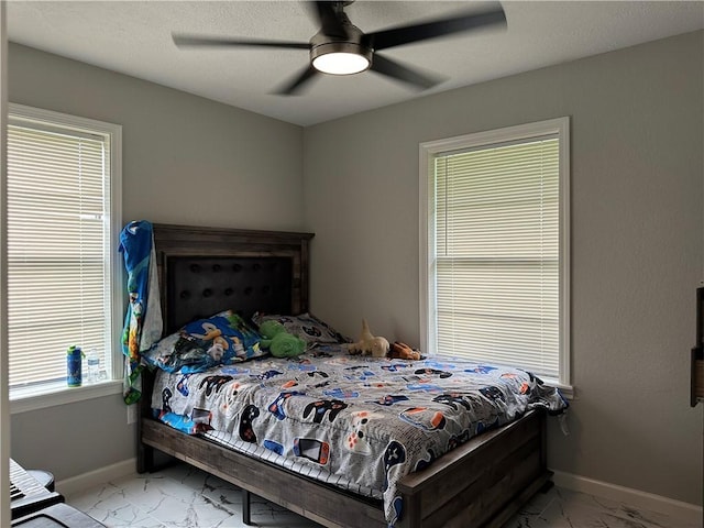 1906 Calvert Cir, Bryan, TX 77803 - bedroom with light marble finish floors and a ceiling fan
