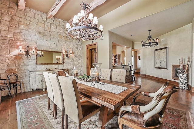 dining area featuring beamed ceiling, dark wood-type flooring, and a notable chandelier