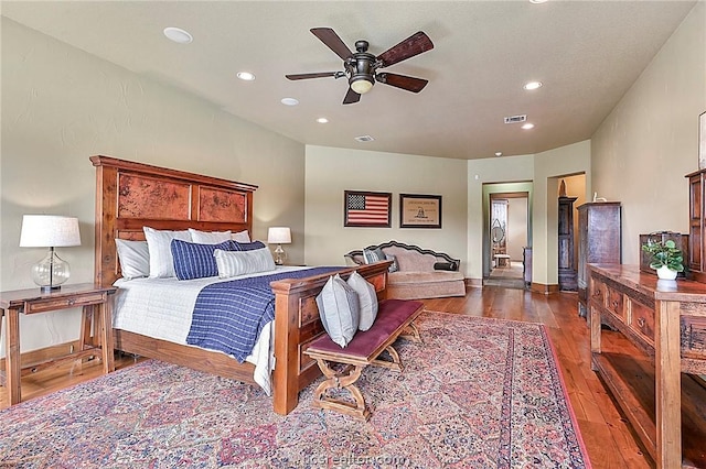 bedroom with ceiling fan and dark hardwood / wood-style floors