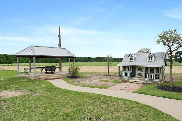 view of community with an outbuilding, a gazebo, and a yard