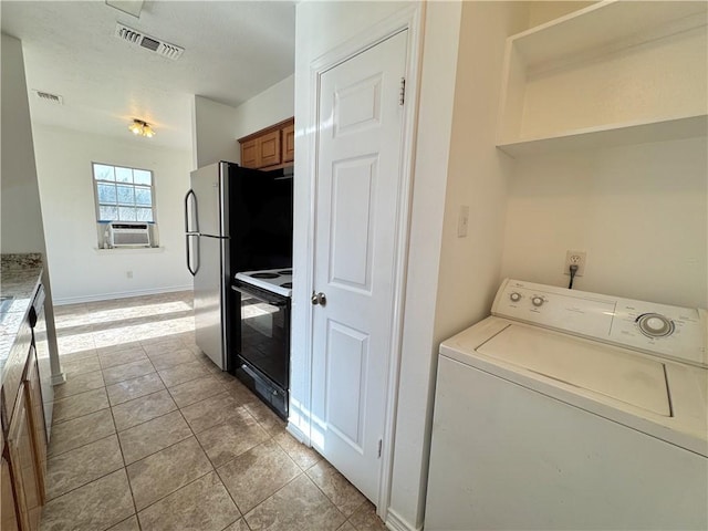 interior space featuring washer / dryer, light tile patterned floors, visible vents, range with electric cooktop, and cooling unit