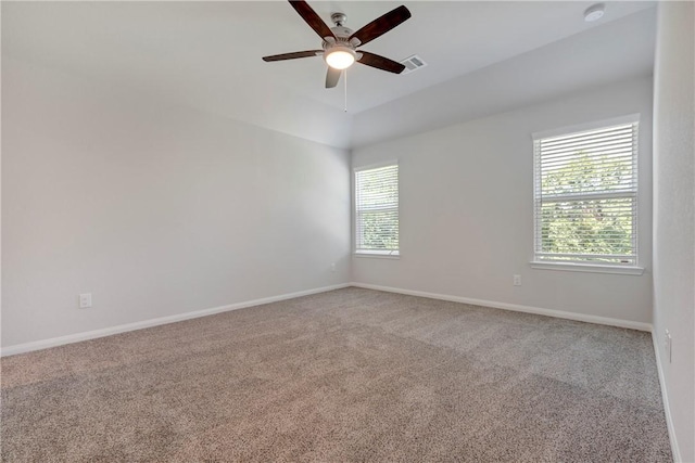 empty room featuring ceiling fan and carpet floors