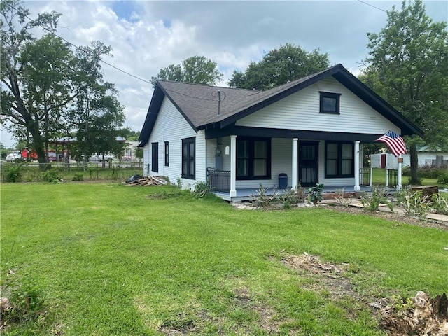 5225 Colorado St, Richards, TX 77873 - rear view of house featuring covered porch, a lawn, and a shingled roof