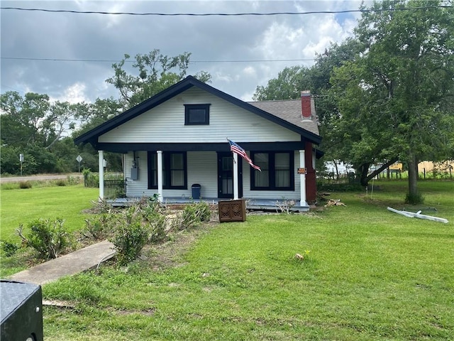5225 Colorado St, Richards, TX 77873 - bungalow featuring covered porch, a chimney, and a front lawn