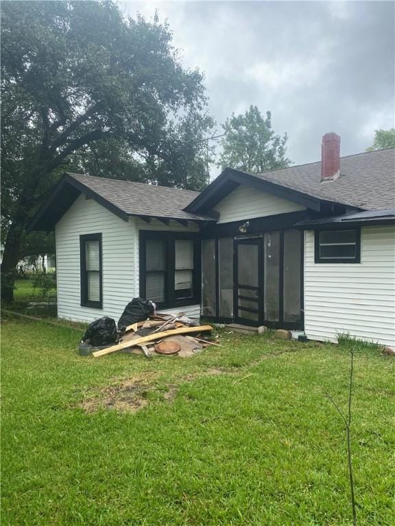 5225 Colorado St, Richards, TX 77873 - back of house with roof with shingles and a yard