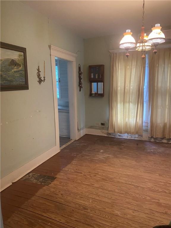 5225 Colorado St, Richards, TX 77873 - empty room with wood finished floors and a chandelier