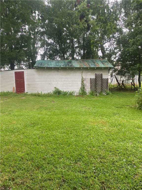 5225 Colorado St, Richards, TX 77873 - view of green lawn featuring an outdoor structure