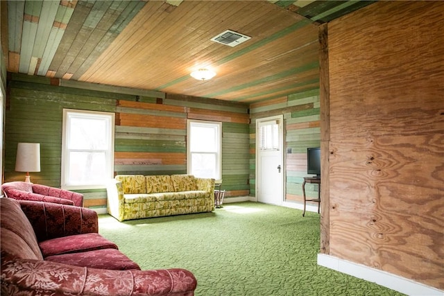 400 N Brazos St, Burton, TX 77835 - carpeted living area with wooden ceiling, plenty of natural light, wood walls, and visible vents