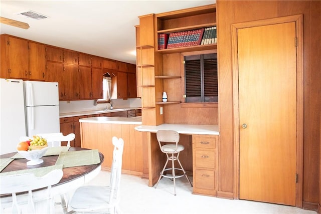 400 N Brazos St, Burton, TX 77835 - kitchen with brown cabinetry, open shelves, and light countertops