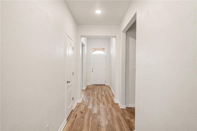 corridor with light wood-type flooring