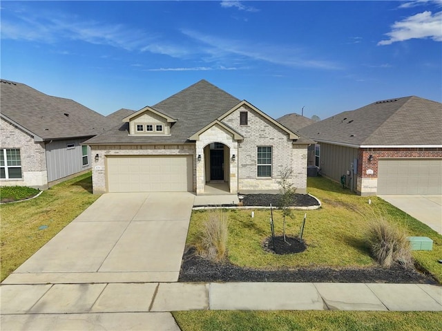 view of front of home with a garage and a front lawn