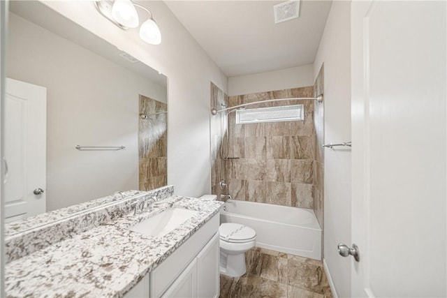 full bathroom with vanity, tiled shower / bath combo, and toilet