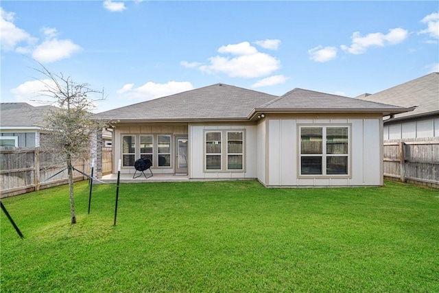 back of house with a lawn and a patio area