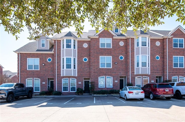 view of building exterior with uncovered parking