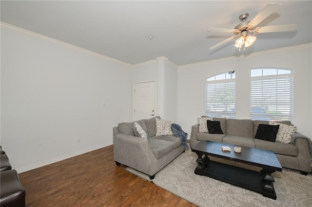 living area featuring baseboards, wood finished floors, a ceiling fan, and crown molding