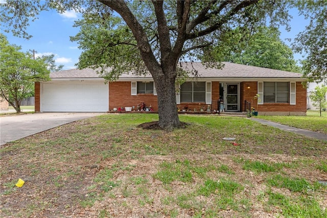 single story home featuring brick siding, driveway, a front yard, and a garage