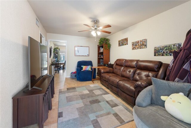 living area featuring visible vents and a ceiling fan