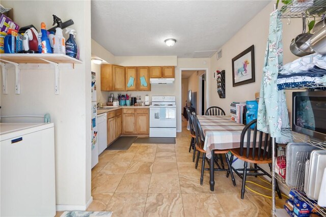 kitchen featuring light countertops, white appliances, visible vents, and under cabinet range hood