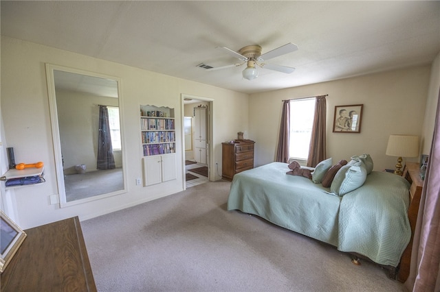4988 Paso Fino Ln, Madisonville, TX 77864 - carpeted bedroom with ensuite bathroom and ceiling fan