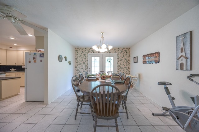4988 Paso Fino Ln, Madisonville, TX 77864 - dining space featuring wallpapered walls, a chandelier, light tile patterned floors, and a ceiling fan