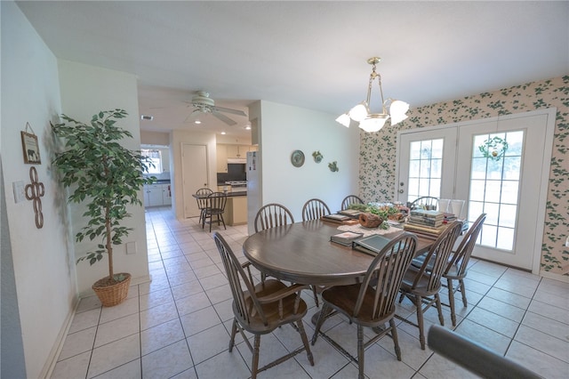 4988 Paso Fino Ln, Madisonville, TX 77864 - dining area with light tile patterned floors, wallpapered walls, a chandelier, baseboards, and a ceiling fan