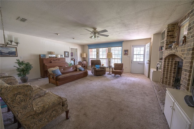 4988 Paso Fino Ln, Madisonville, TX 77864 - living room featuring a textured ceiling, a ceiling fan, a brick fireplace, and light carpet