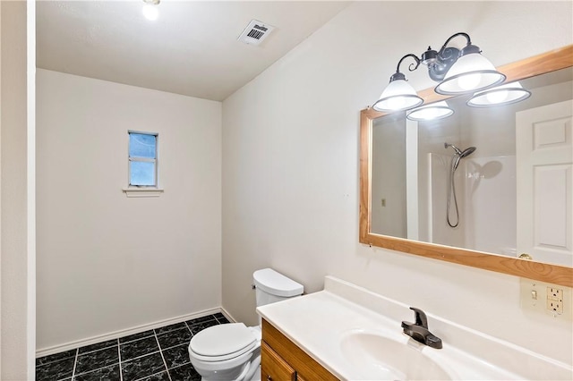 bathroom featuring vanity, tile patterned flooring, toilet, and a shower