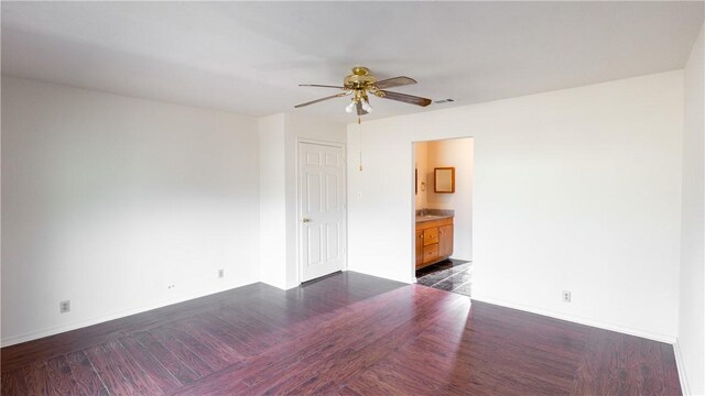 spare room with dark hardwood / wood-style floors and ceiling fan
