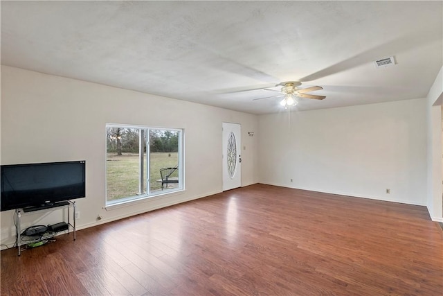 unfurnished living room featuring ceiling fan and dark hardwood / wood-style flooring