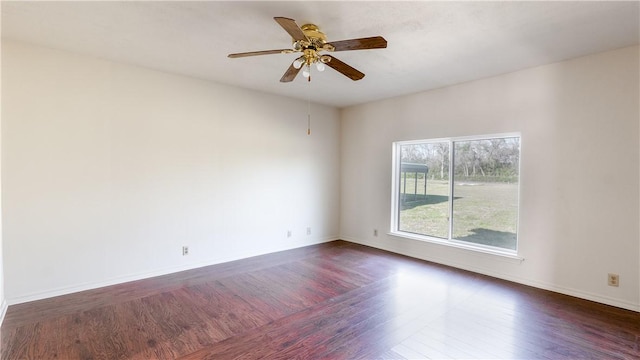 empty room with dark hardwood / wood-style floors and ceiling fan