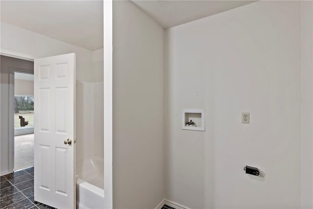 laundry area with hookup for a washing machine and dark tile patterned floors