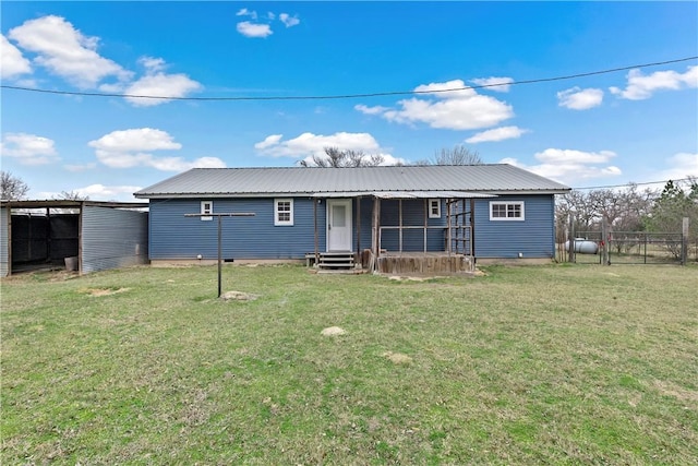 rear view of property with a yard