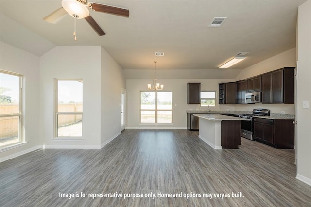 kitchen featuring pendant lighting, plenty of natural light, stainless steel appliances, and hardwood / wood-style floors