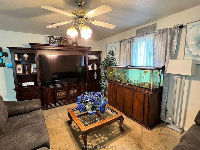 living room with ceiling fan, light colored carpet, and a textured ceiling