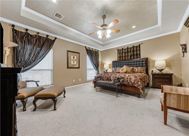 bedroom with crown molding, a raised ceiling, and carpet floors