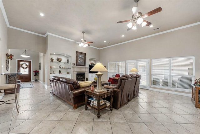 tiled living room with a high ceiling, ornamental molding, and ceiling fan